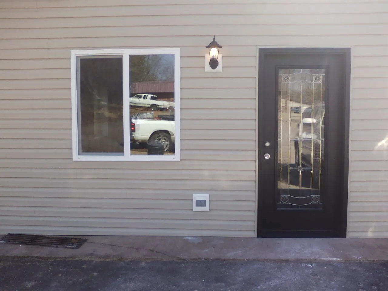 New siding, window and entry door on the side of an addition in Powhatan Point